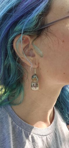 Add a touch of magic to your style with these Wax Sealed Gemstone Shard Earrings! Each pair features tiny gemstone shards encased in potion bottles, sealed with wax for a mystical, handcrafted look. These dangle earrings are perfect for anyone who loves unique, fantasy-inspired accessories that bring a bit of enchantment to their wardrobe. Lightweight and eye-catching, they're ideal for casual wear or special occasions. Whether you're a lover of crystals, magic, or whimsical jewelry, these gemstone potion bottle earrings are the perfect statement piece! Prescription Bottle Earrings, Crystals Magic, Potion Bottles, Bottle Earrings, Whimsical Jewelry, Potion Bottle, Wax Seals, Jewelry Earrings Dangle, Dangle Drop Earrings