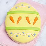 a decorated cookie sitting on top of a pink towel