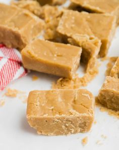 several pieces of peanut butter fudge on a white surface