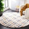 a living room with a white chair and rug