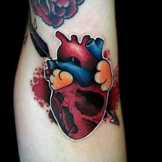 a heart and arrow tattoo on the left side of someone's leg, with blood splatters all over it