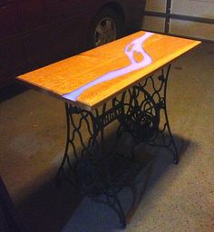 a table that is sitting in the middle of a room with a car parked next to it