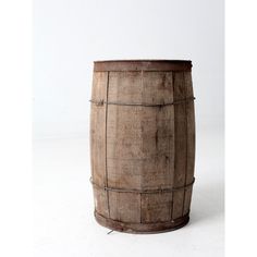 a wooden barrel sitting on top of a white floor