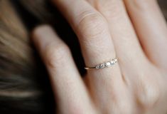 a woman's hand with a diamond ring on it