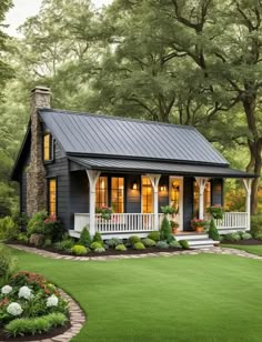 a small blue house with white trim and windows on the front porch is surrounded by lush green grass