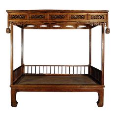 an antique wooden bed with four drawers on the top and bottom, sitting in front of a white background