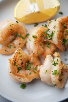 shrimp with lemon and parsley on a white plate