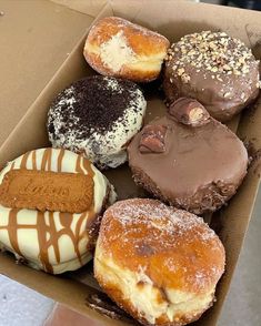 a box filled with lots of different flavored donuts