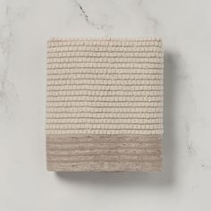 a white and beige towel sitting on top of a counter