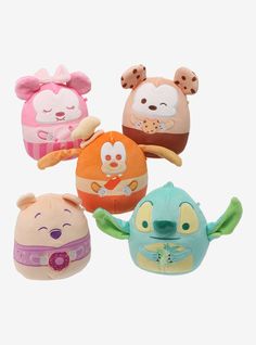 four small stuffed animals sitting next to each other