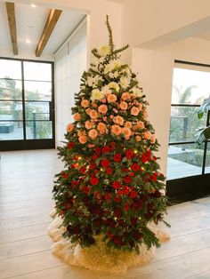 a christmas tree decorated with red and white flowers