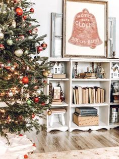 a christmas tree in front of a bookshelf