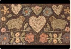 the rug has hearts and sheeps on it, with flowers in the middle to make them look like they have been hooked up together