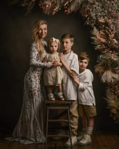 a woman and two children posing for a photo