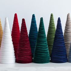 there are many different colored cones on the shelf in front of each other, all lined up and ready to be used as decorations