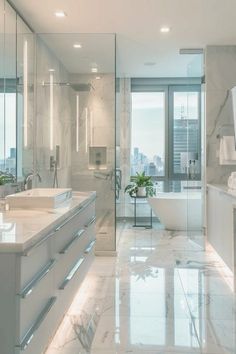 a bathroom with two sinks and a bathtub next to a large window overlooking the city