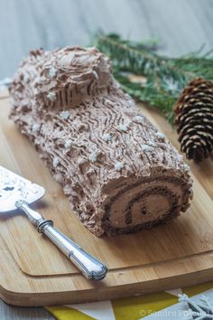 a piece of cake sitting on top of a wooden cutting board next to a knife