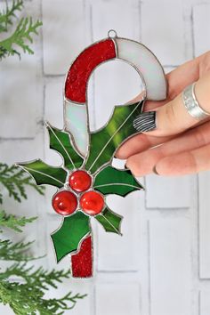 a hand holding a christmas decoration ornament