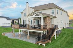 a large house with a deck and stairs