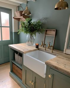 a white sink sitting under a window next to a wooden counter top in a kitchen