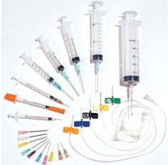 an assortment of medical equipment including sys and needled end caps on a white background