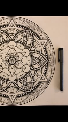 a pen and ink drawing of a flower in the middle of a circle with an intricate design on it