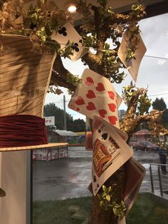 a tree with cards hanging from it's branches in front of a store window