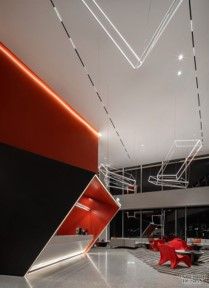 an empty lobby with red and black furniture