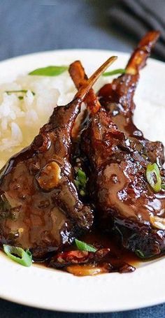 some meat and rice on a white plate