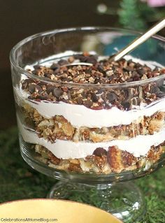 an image of a dessert in a bowl on the grass with spoons and fork