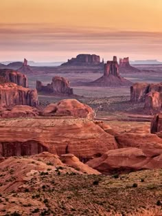 the desert is full of rock formations at sunset