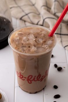 there is a drink with ice in it on the table next to some donuts