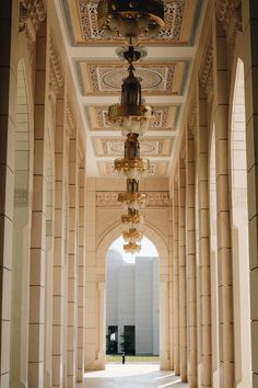 an archway with chandeliers hanging from it's ceiling in a large building