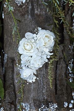 a bouquet of white flowers sitting on top of a tree