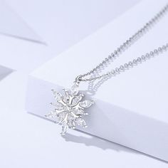 Description & Details Embrace the enchanting beauty of winter with our intricately crafted pieces inspired by the delicate and unique snowflakes. Each design in our collection captures the mesmerizing allure and symbolism associated with these crystalline wonders. • Material: Solid 925 Sterling Silver ∙ Cubic Zirconia• Finish: Hypoallergenic ∙ Gold Plating• Dimensions: 14 x 16 mm pendant, 40 - 45 cm chain, adjustable• All our work is custom made by hand with love Unique Snowflakes, Beauty Of Winter, Snowflake Necklace, Snowflake Pendant, Silver Snowflakes, Solid 925 Sterling Silver, Gold Plating, Couple Gifts, Sales Gifts