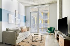 a living room filled with furniture and a flat screen tv