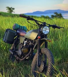 a dirt bike parked on top of a lush green field