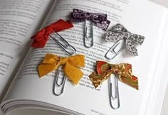 several small bow clips are placed on an open book