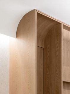 an empty wooden cabinet in a white room