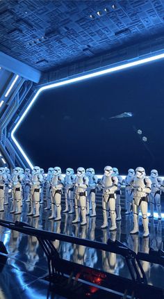 star wars action figures are lined up in front of a stage with lights and mirrors