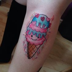 an ice cream cone with hearts on it is painted in blue and pink, as well as sprinkles