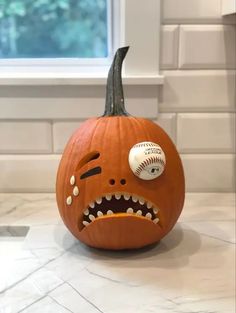 a pumpkin with a baseball in it's mouth