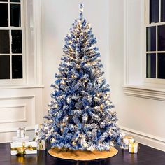 a blue and white christmas tree in a room