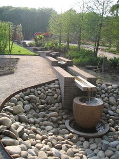 there is a water fountain in the middle of some rocks