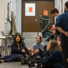 a group of young people sitting on the floor