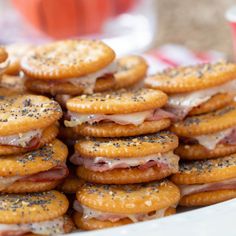 a plate full of crackers with ham and cheese on them next to a cup of coffee