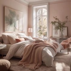 a bedroom with pink walls, white bedding and an art work on the wall