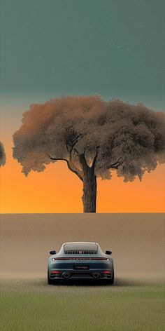 a car parked in front of a tree on the side of a road with an orange sky behind it