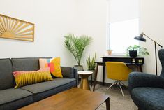 a living room filled with furniture next to a table and chair in front of a window