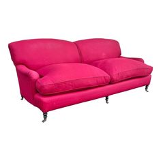 a pink couch sitting on top of a white floor